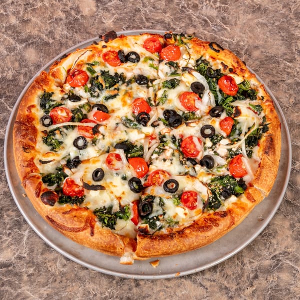 Mr. G's Pizzeria's whole pizza with spinach, cherry tomatoes, black olives, and onions.